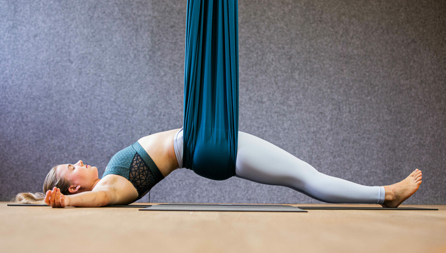 woman doing aerial yoga